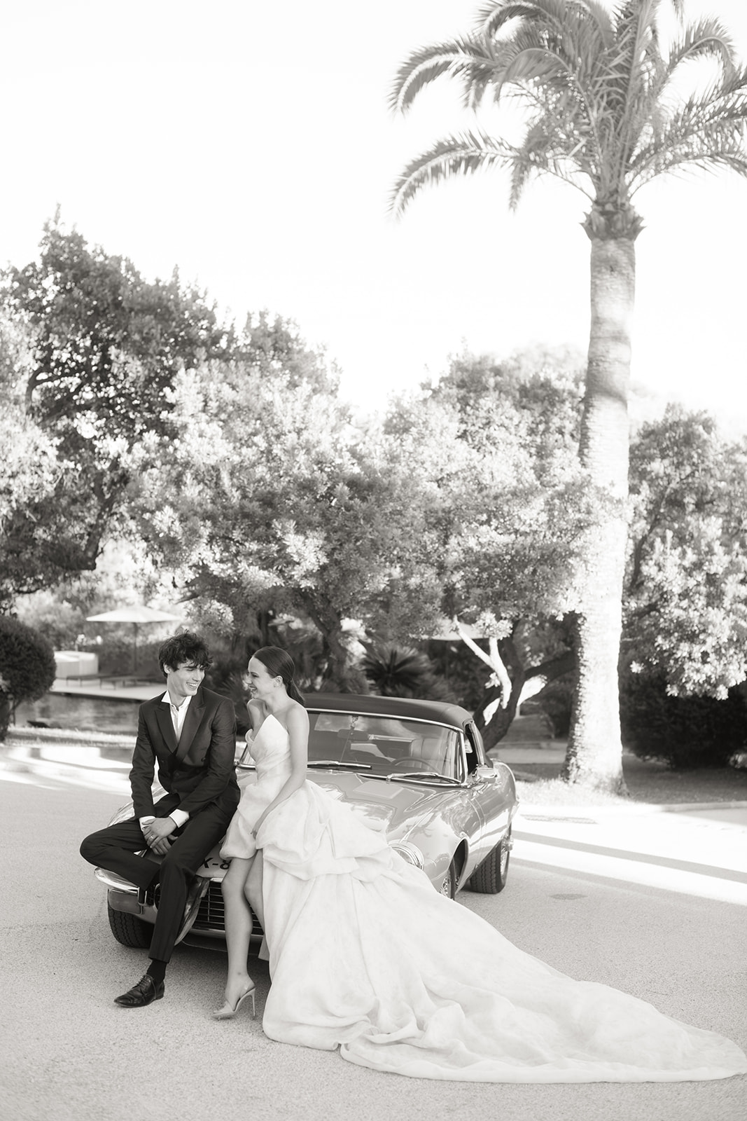 Bride and groom photographed with a classic Jaguar near Saint-Tropez
